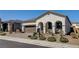 Beautiful single-story home featuring arched entryway, desert landscaping, and a two-car garage at 10064 Ocher Valley Ave, Las Vegas, NV 89178