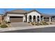 Attractive single-Gathering home featuring a paver driveway, desert landscaping, and a tile roof at 10064 Ocher Valley Ave, Las Vegas, NV 89178