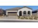 Charming single-story home with a two-car garage, paver driveway, and drought-tolerant landscaping at 10064 Ocher Valley Ave, Las Vegas, NV 89178