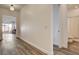 Bright hallway featuring modern flooring, white walls, and access to the bathroom and living area at 10064 Ocher Valley Ave, Las Vegas, NV 89178
