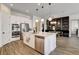 Modern kitchen with island, white cabinets, stainless steel appliances and an adjacent dining area at 10064 Ocher Valley Ave, Las Vegas, NV 89178