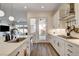 Contemporary kitchen featuring a kitchen island, access to the patio, and stainless steel appliances at 10064 Ocher Valley Ave, Las Vegas, NV 89178