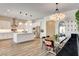 Bright, open kitchen with white cabinets, a large island, stainless steel appliances, and modern lighting at 10064 Ocher Valley Ave, Las Vegas, NV 89178