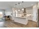 Open concept kitchen with an island, modern lighting, access to the living room, and stainless steel appliances at 10064 Ocher Valley Ave, Las Vegas, NV 89178