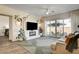 Bright living room featuring a modern fireplace, stylish rug, and sliding glass doors to the patio at 10064 Ocher Valley Ave, Las Vegas, NV 89178