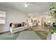 Open concept living area with wood flooring, view into kitchen and dining area with access to the patio at 10064 Ocher Valley Ave, Las Vegas, NV 89178