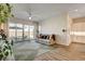 Spacious living room with wood floors, sliding glass doors to the yard, and view into the kitchen at 10064 Ocher Valley Ave, Las Vegas, NV 89178