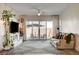 Cozy living room with sliding glass doors leading to the backyard and stylish indoor plants at 10064 Ocher Valley Ave, Las Vegas, NV 89178