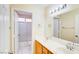 Bright bathroom with double sink vanity, large mirror, and a separate shower area at 1016 Wannamaker Way, Henderson, NV 89015