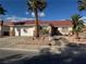 Charming single-story home featuring a well-manicured front yard with desert landscaping and mature palm trees at 1016 Wannamaker Way, Henderson, NV 89015
