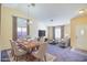 Inviting living and dining room with large windows and neutral color palette, perfect for entertaining at 1016 Wannamaker Way, Henderson, NV 89015