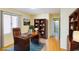 Functional office space with a large desk, bookshelf, and convenient access to the bathroom at 1016 Wannamaker Way, Henderson, NV 89015