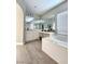 Bathroom with a large tub, vanity with double sinks, and wood-look floors at 10215 Radcliffe Peak Ave, Las Vegas, NV 89166