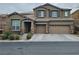 Two-story home with a three-car garage and a well-maintained front yard and stone veneer at 10215 Radcliffe Peak Ave, Las Vegas, NV 89166
