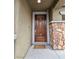 Elegant wood front door framed by stone accents, offering a warm welcome to this lovely home at 10215 Radcliffe Peak Ave, Las Vegas, NV 89166