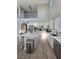Well-appointed kitchen featuring white cabinetry, an island, and stainless steel appliances at 10215 Radcliffe Peak Ave, Las Vegas, NV 89166