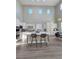 Bright, open kitchen with white cabinets, an island, stainless appliances, and soaring ceilings at 10215 Radcliffe Peak Ave, Las Vegas, NV 89166