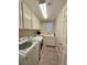 Laundry room with a utility sink, washer, dryer, and ample cabinet space at 10215 Radcliffe Peak Ave, Las Vegas, NV 89166