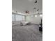 Spacious living room with carpet, ceiling fan, recessed lights and large windows at 10215 Radcliffe Peak Ave, Las Vegas, NV 89166
