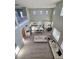 Open-concept living room and kitchen with hardwood floors and natural light from large windows at 10215 Radcliffe Peak Ave, Las Vegas, NV 89166