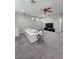 Comfortable living room with plush carpet, and large windows at 10215 Radcliffe Peak Ave, Las Vegas, NV 89166