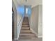 Staircase with wood steps and white banister leading to the upper level of the home at 10215 Radcliffe Peak Ave, Las Vegas, NV 89166