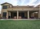 Backyard featuring grass, covered patio, and balcony at 10220 Radcliffe Peak Ave, Las Vegas, NV 89166
