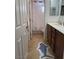 Bathroom with dual sink, wood cabinets, tan tile floors, and a shower-tub combination at 10220 Radcliffe Peak Ave, Las Vegas, NV 89166