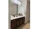 Bathroom featuring neutral countertops with dark wood cabinets and tile floors at 10220 Radcliffe Peak Ave, Las Vegas, NV 89166