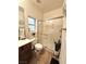 Bathroom with standing shower, tile floors, and a dark wood vanity with white sink at 10220 Radcliffe Peak Ave, Las Vegas, NV 89166