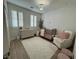 Bright Bedroom features a white rug, light wood floors, and a matching crib and dresser set at 10220 Radcliffe Peak Ave, Las Vegas, NV 89166