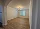 Inviting dining room featuring modern chandelier, window with shutters, and wood floors at 10220 Radcliffe Peak Ave, Las Vegas, NV 89166
