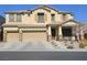 Inviting two-story home with a three-car garage and well-maintained landscaping at 10220 Radcliffe Peak Ave, Las Vegas, NV 89166