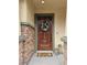 Charming entryway featuring a wood door with decorative wreath and stone accents at 10220 Radcliffe Peak Ave, Las Vegas, NV 89166