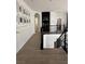 Second floor hallway features a wood floor and black iron railing, leading to the stairway at 10220 Radcliffe Peak Ave, Las Vegas, NV 89166