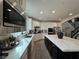 Bright, modern kitchen with white cabinets, stainless appliances, quartz countertops, and a large central island at 10220 Radcliffe Peak Ave, Las Vegas, NV 89166