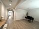 Spacious living area with hardwood floors, piano, and arched doorways at 10220 Radcliffe Peak Ave, Las Vegas, NV 89166
