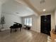 Elegant living room with a piano, large windows, and a modern design at 10220 Radcliffe Peak Ave, Las Vegas, NV 89166