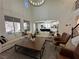 Expansive living room with high ceilings, modern furniture, and natural light at 10220 Radcliffe Peak Ave, Las Vegas, NV 89166