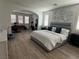 Spacious main bedroom boasts wood floors, exercise area, and decorative accent wall at 10220 Radcliffe Peak Ave, Las Vegas, NV 89166