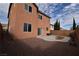 Two-story home featuring backyard with rock landscaping and artificial turf at 10511 Loma Portal Ave, Las Vegas, NV 89166