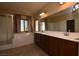 Bright bathroom featuring double sinks, soaking tub, and separate shower at 10511 Loma Portal Ave, Las Vegas, NV 89166