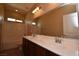 Bright bathroom featuring double sinks, large mirror, and shower/tub combination at 10511 Loma Portal Ave, Las Vegas, NV 89166