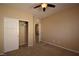 Well lit bedroom with neutral carpet, closet with sliding doors, and access to second story landing at 10511 Loma Portal Ave, Las Vegas, NV 89166