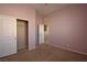 Cozy bedroom with closet, neutral carpet, open doorway, and light pink walls at 10511 Loma Portal Ave, Las Vegas, NV 89166