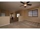 Open bonus room with natural light, neutral carpet, and a standard ceiling fan at 10511 Loma Portal Ave, Las Vegas, NV 89166