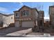 Beautiful two-story home featuring a paved driveway, two-car garage and desert landscaping at 10511 Loma Portal Ave, Las Vegas, NV 89166