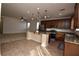 Open concept kitchen with granite countertops, stainless steel appliances, and tile flooring at 10511 Loma Portal Ave, Las Vegas, NV 89166