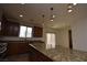 Kitchen with granite counters, wood cabinets, and stainless steel appliances at 10511 Loma Portal Ave, Las Vegas, NV 89166