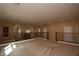 Upstairs landing featuring neutral carpet, black railing, and natural light at 10511 Loma Portal Ave, Las Vegas, NV 89166